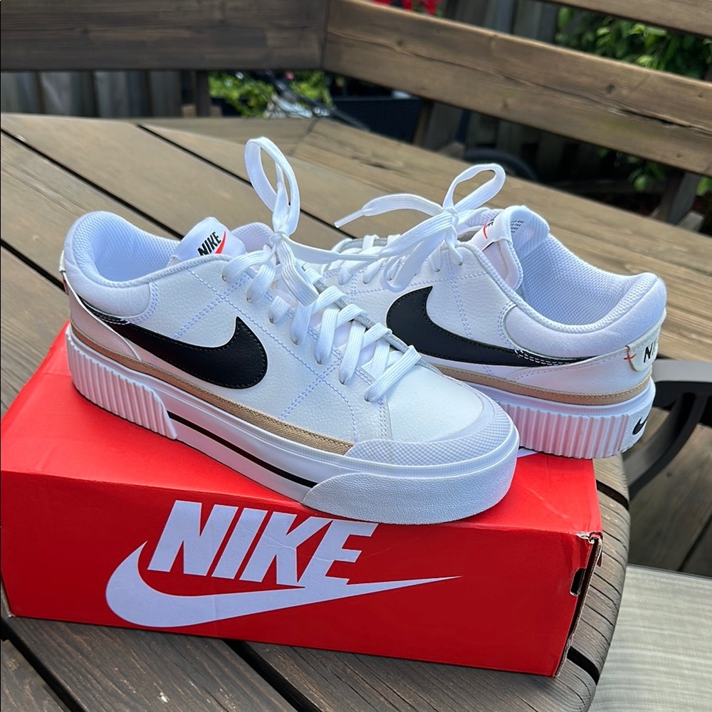 Nike White and Black Sneakers with Gold Stripe
